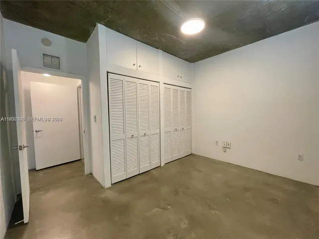 an empty room with closet area