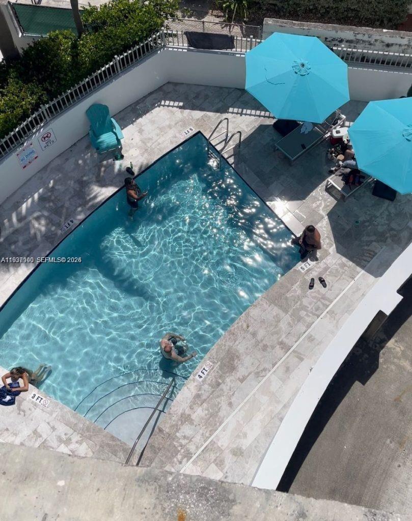 455 Northeast 25th Street, Unit 407 Miami, FL 33137 - Photo 47 of 50 a picture of table and chairs with wooden fence