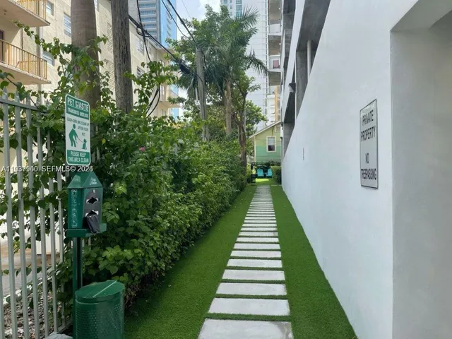 an outdoor sitting area with furniture and garden