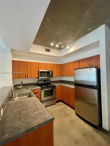 a kitchen with stainless steel appliances a stove cabinets and a counter top