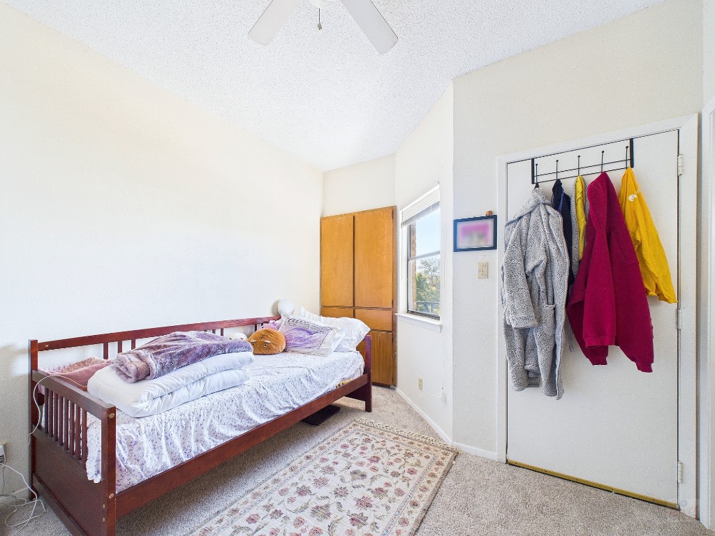 3316 Guadalupe Street, Unit 321 Austin, TX 78705 - Photo 11 of 13 a bedroom with a bed and a couch