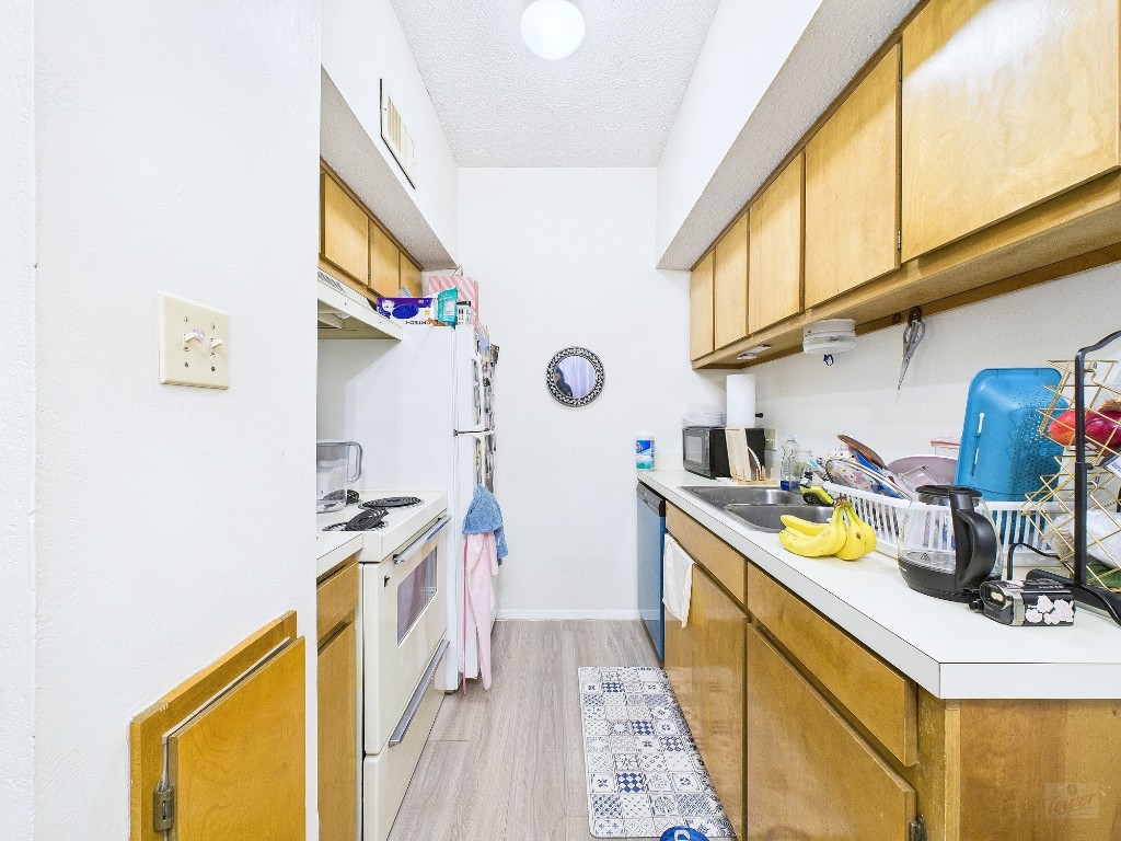 3316 Guadalupe Street, Unit 321 Austin, TX 78705 - Photo 5 of 13 a kitchen with stainless steel appliances granite countertop a sink and cabinets
