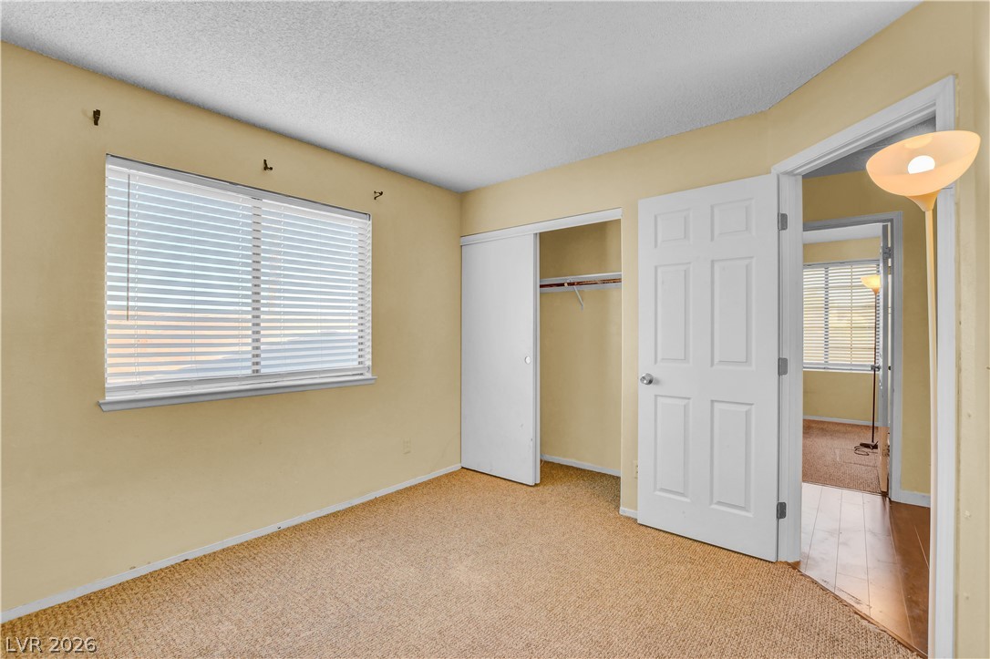 6440 Hartwood Road Las Vegas, NV 89108 - Photo 43 of 59 A window with venetian blinds illuminates this cozy room with durable carpet and a convenient closet.