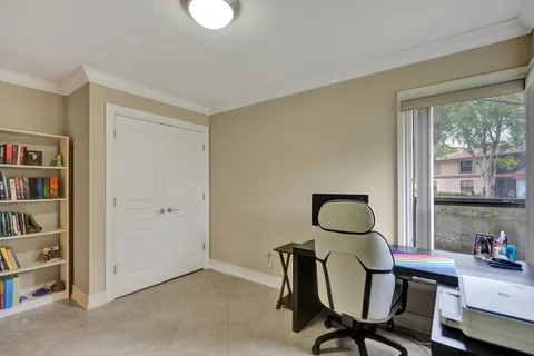 a view of a workspace with furniture and a window