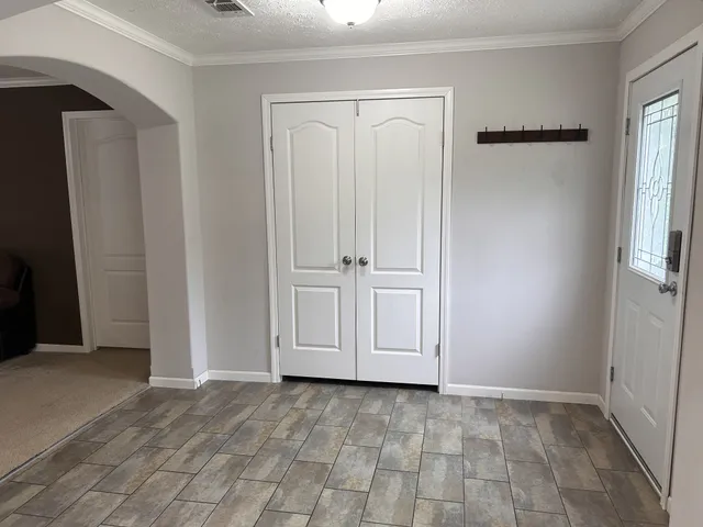 a backyard of a house with lots of green space and lake view