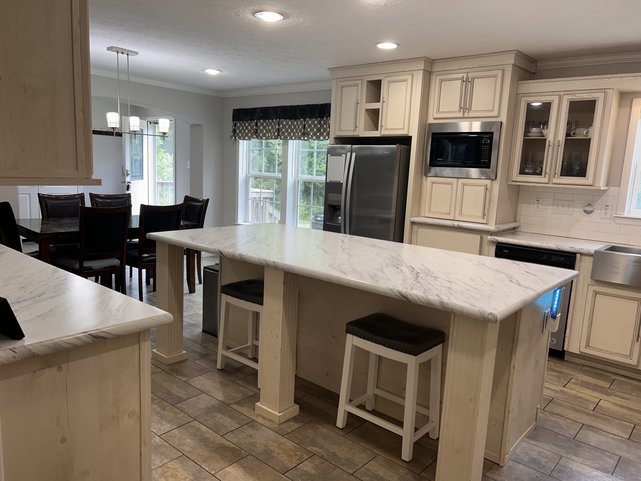 7111 Wink Parker Road Lyles, TN 37098 - Photo 15 of 47 a kitchen with stainless steel appliances kitchen island granite countertop a refrigerator a stove a sink a dining table and chairs with wooden floor