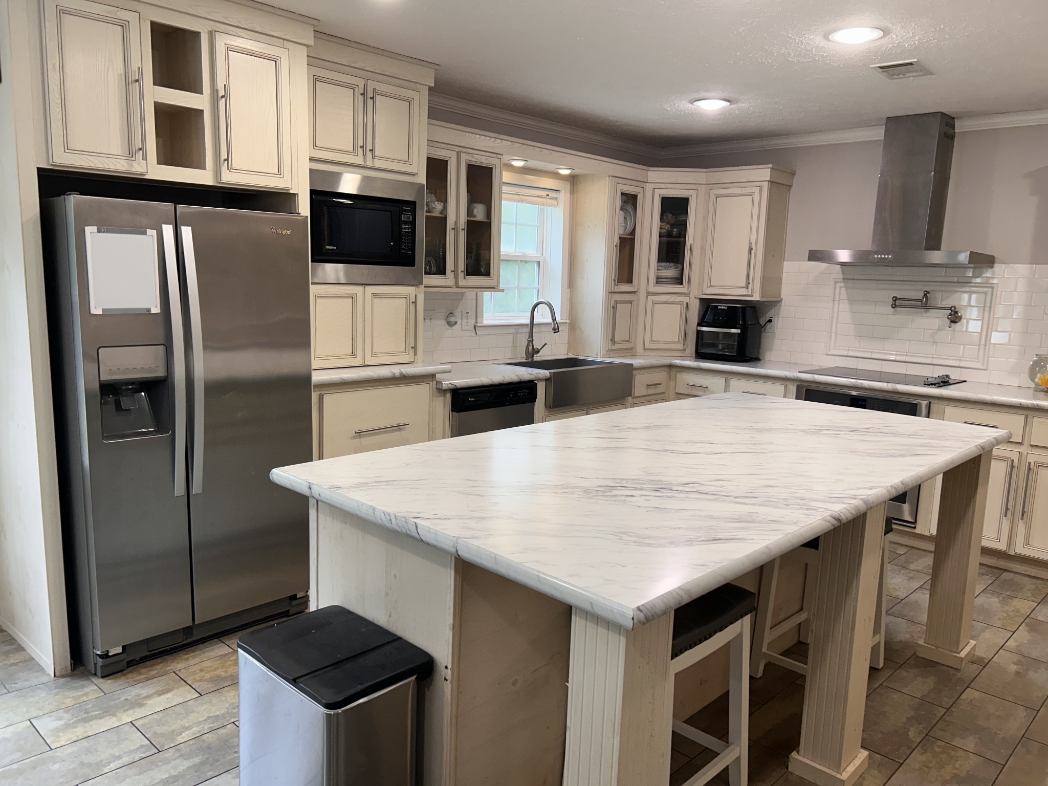 7111 Wink Parker Road Lyles, TN 37098 - Photo 17 of 47 a kitchen with stainless steel appliances granite countertop a kitchen island a stove a refrigerator a sink a dining table and chairs