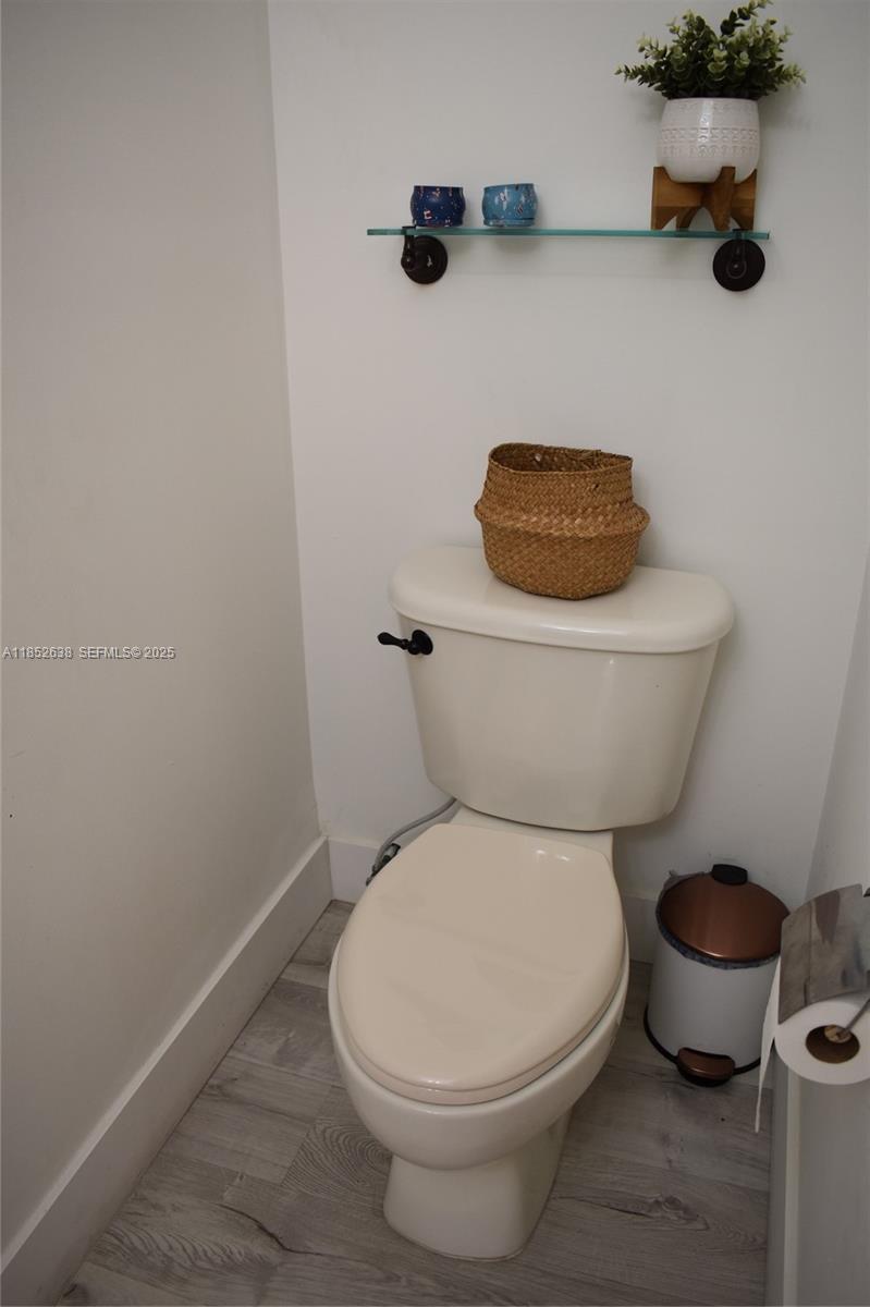 5189 Northwest 108th Path Doral, FL 33178 - Photo 12 of 23 a white toilet sitting next to a white tub and a sink