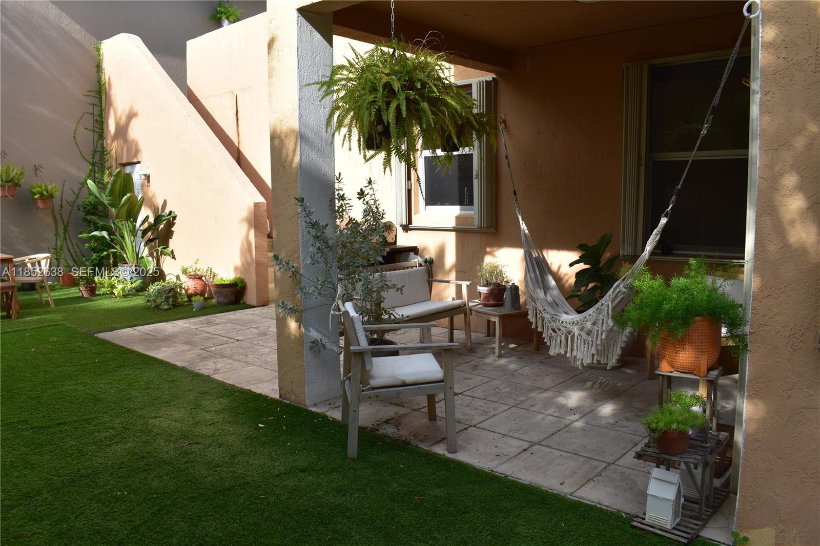 5189 Northwest 108th Path Doral, FL 33178 - Photo 21 of 23 a view of a backyard with plants and a fountain