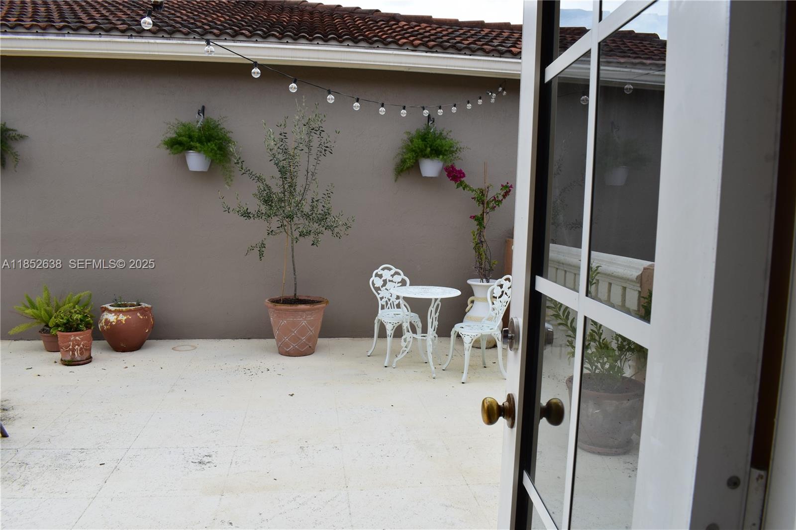 5189 Northwest 108th Path Doral, FL 33178 - Photo 22 of 23 a view of table and chair with potted plant