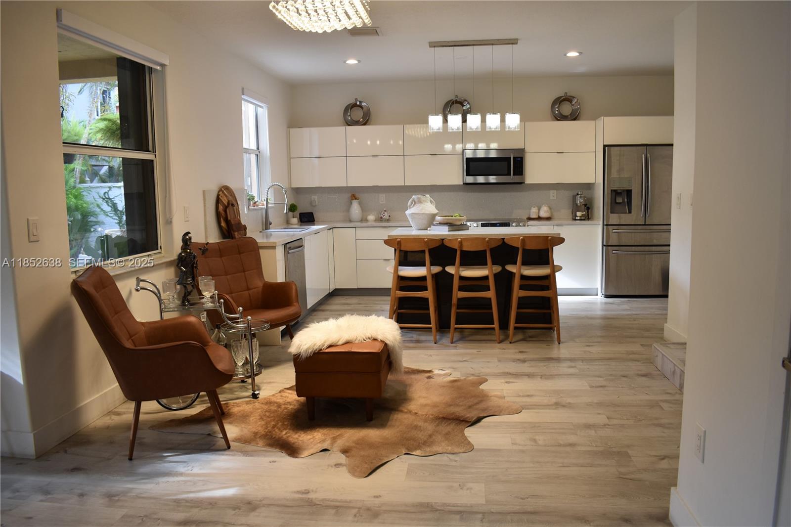 5189 Northwest 108th Path Doral, FL 33178 - Photo 4 of 23 a living room with stainless steel appliances furniture a rug and a kitchen view