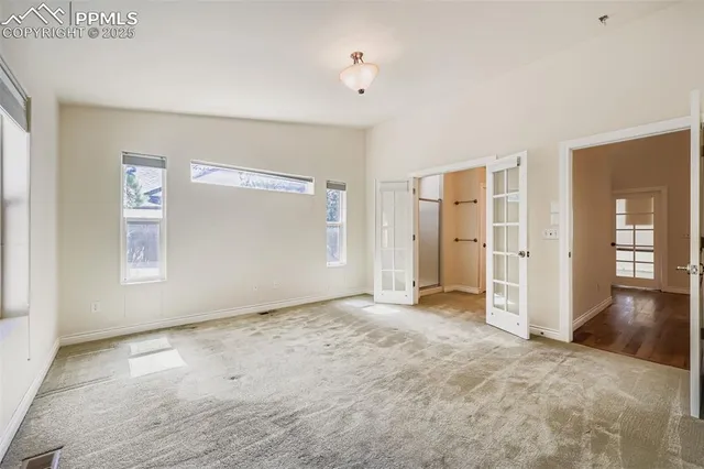 an empty room with windows and closet