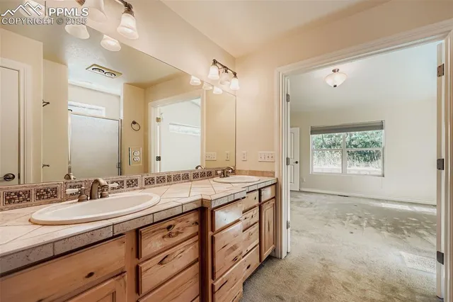 a bathroom with a granite countertop sink mirror and double