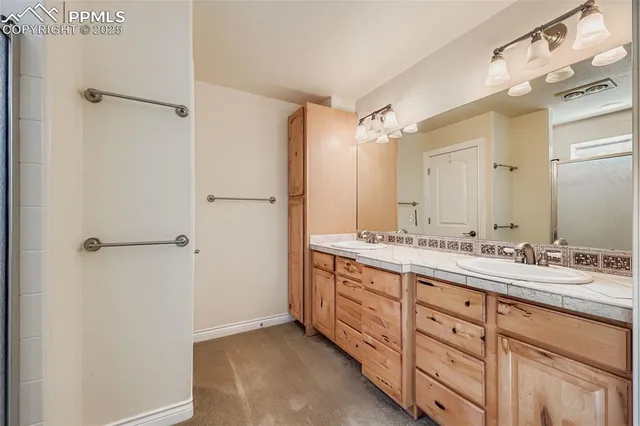 a bathroom with a double vanity sink mirror and double