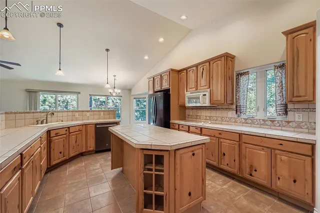 a kitchen with a stove top oven sink and cabinets