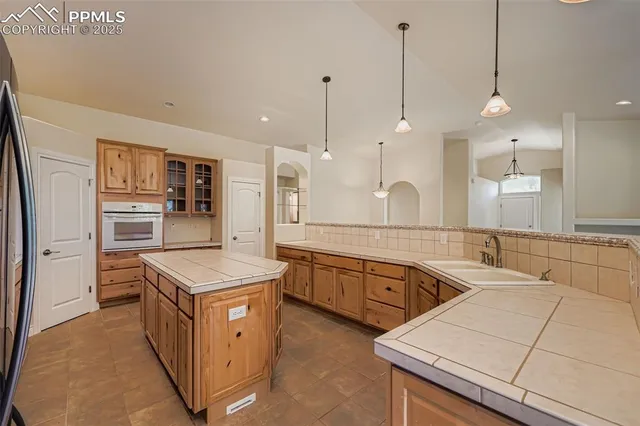 a kitchen with white cabinets and appliances