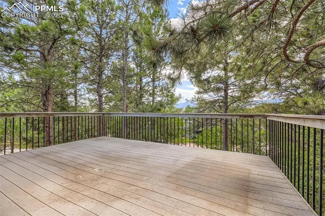 a view of balcony with wooden floor and fence