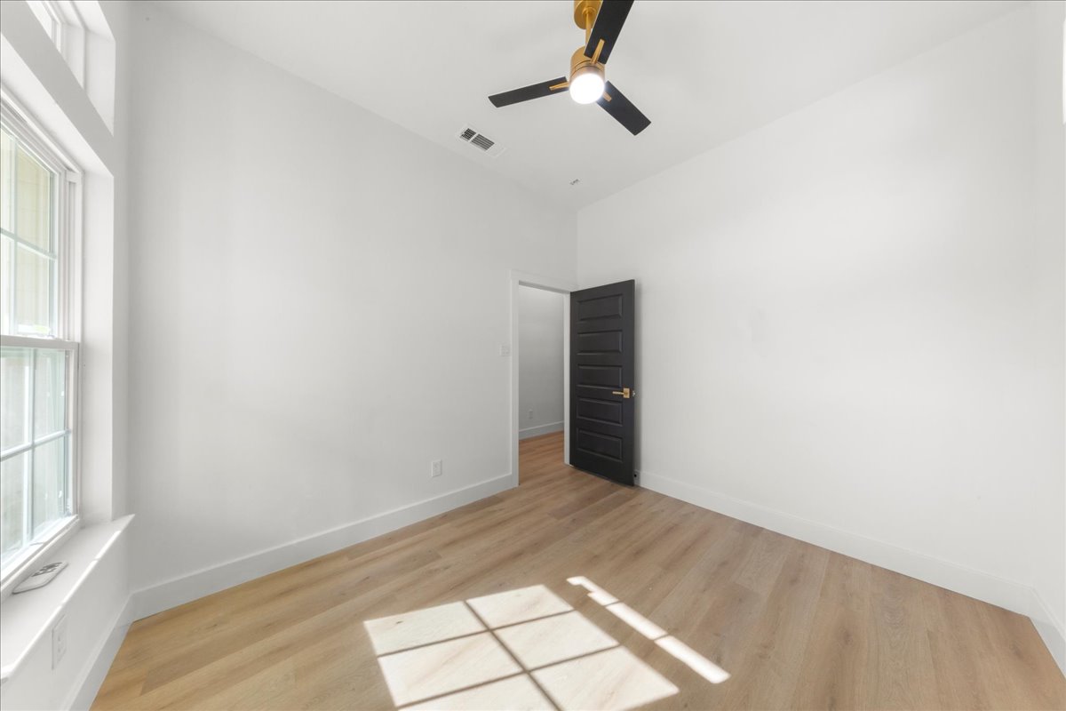 2408 Vintage Stave Road, Unit 101 Austin, TX 78748 - Photo 16 of 32 Spare room featuring light wood-style flooring and ceiling fan