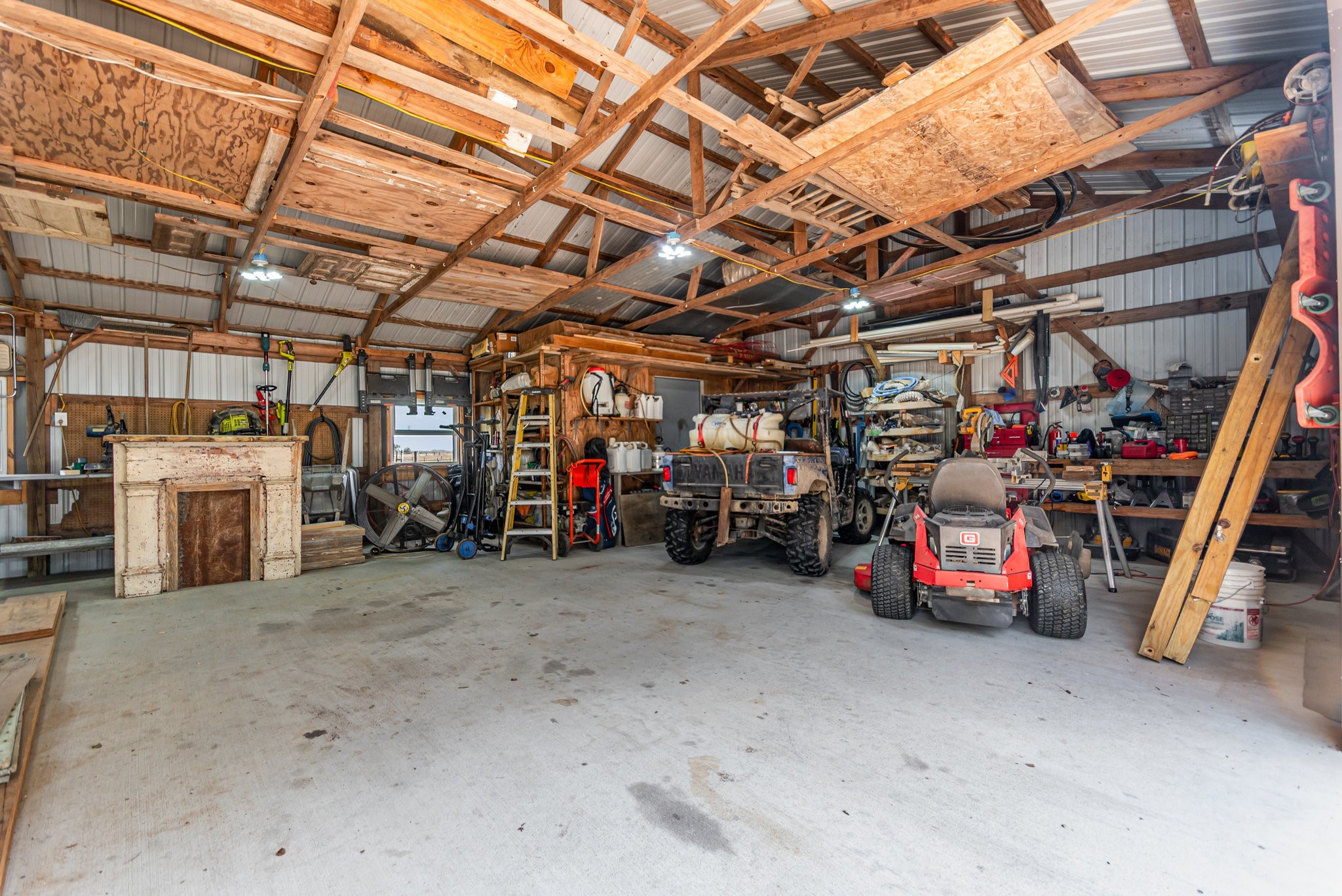 12009 Dannhaus Road Needville, TX 77461 - Photo 26 of 49 a view of a garage with furniture and a garage