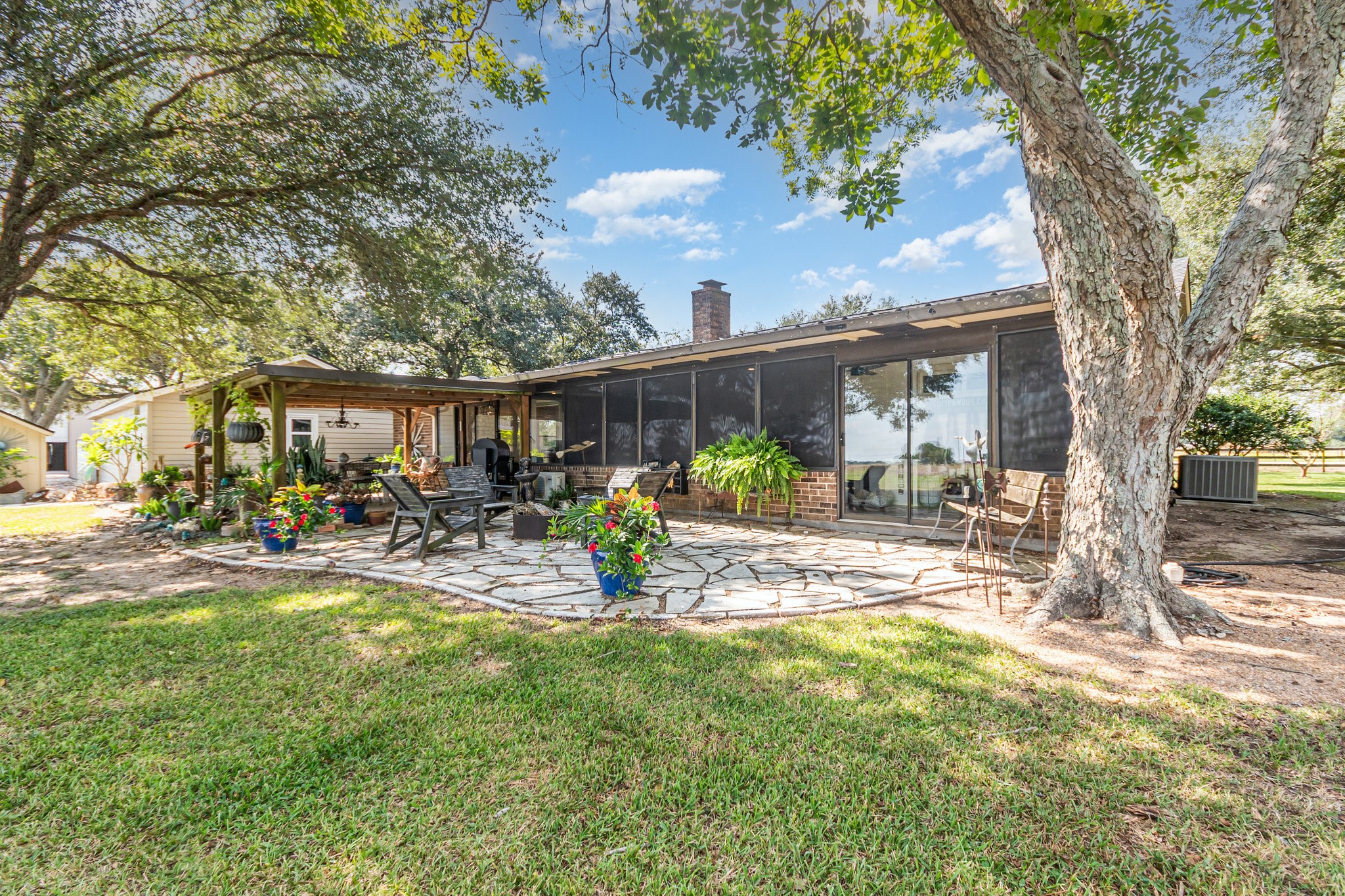 12009 Dannhaus Road Needville, TX 77461 - Photo 28 of 49 a view of a house with backyard and sitting area