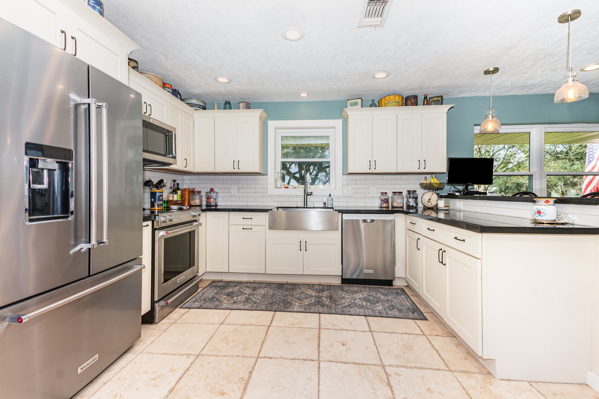 12009 Dannhaus Road Needville, TX 77461 - Photo 9 of 49 a kitchen with granite countertop a stove top oven sink and cabinets