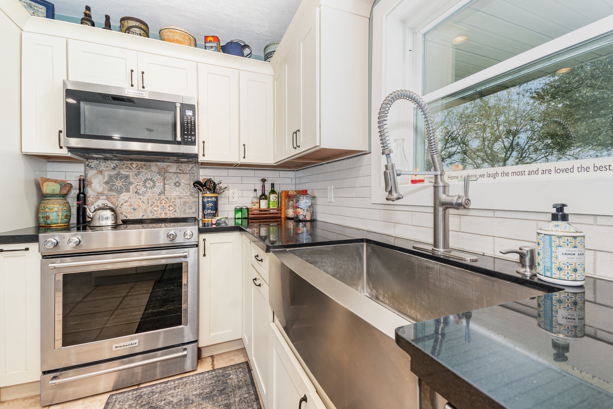 12009 Dannhaus Road Needville, TX 77461 - Photo 10 of 49 a kitchen with stainless steel appliances granite countertop a sink a stove and a microwave