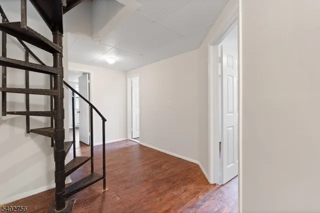 a view of an entryway with wooden floor