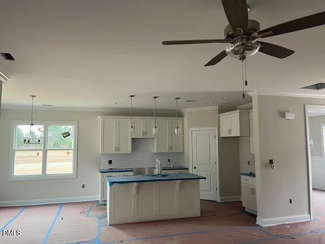 a kitchen with stainless steel appliances a stove a refrigerator and white cabinets