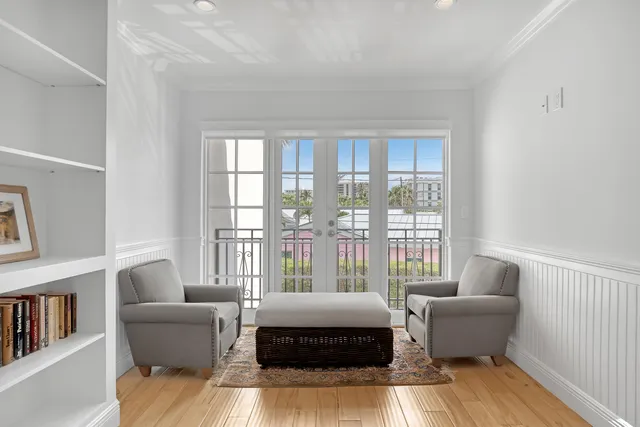 a living room with furniture and a book shelf