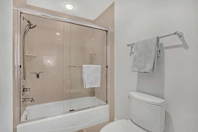 a bedroom with a bed and a lamp