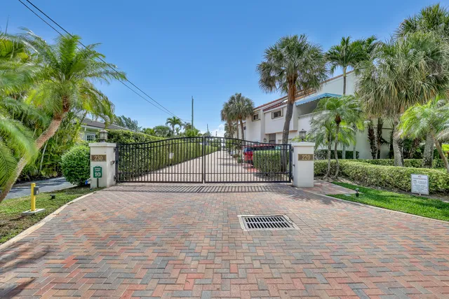 an aerial view of a house with a garden and lake view