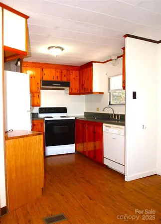 a view of a room with wooden floor and a window