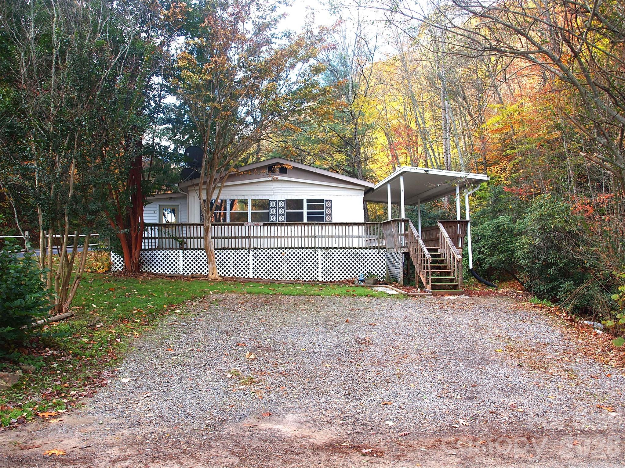 9 Smokey Cove Road Canton, NC 28716 - Photo 3 of 26 a front view of a house with a yard and trees