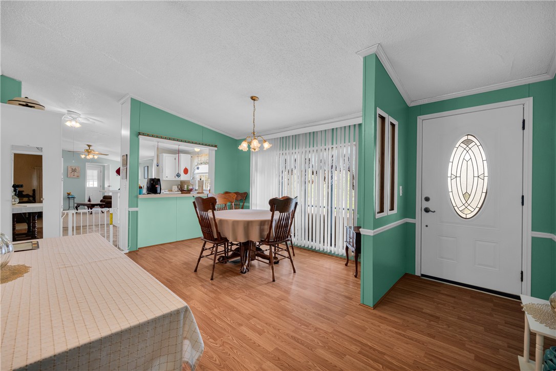 721 Cedar Crest Trail Walhalla, SC 29691 - Photo 46 of 47 Enter into a bright, open floorplan with wood-look flooring and crown molding, seamlessly connecting dining and kitchen spaces.