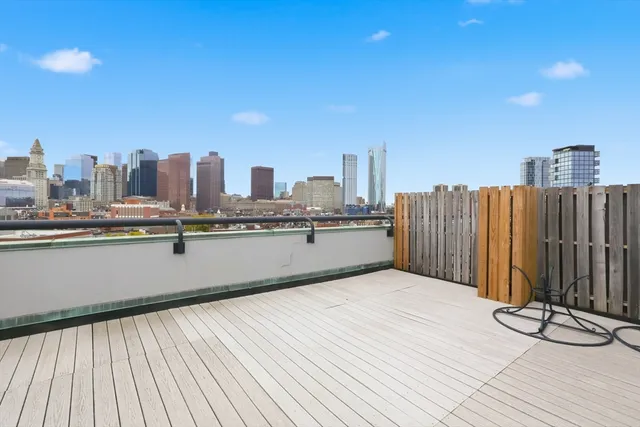 a view of a terrace with wooden floor and fence