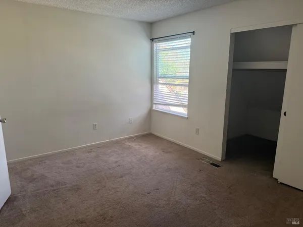 a living room with furniture a flat screen tv and a floor to ceiling window