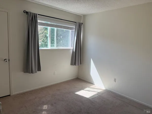 a bedroom with a bed and dresser with mirror