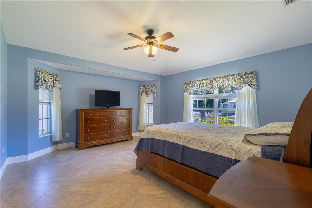 414 Ash Street Sebastian, FL 32958 - Photo 17 of 36 a bedroom with a bed and a large window