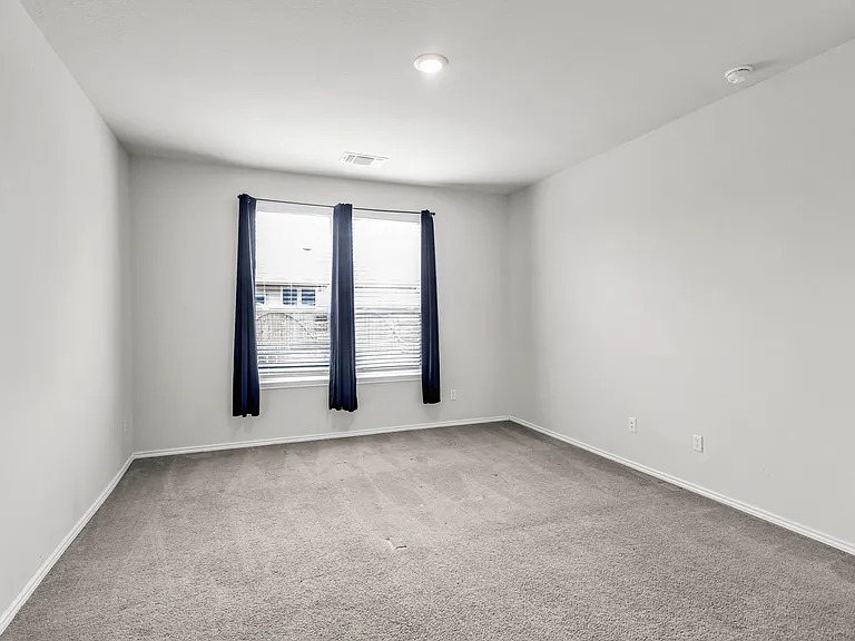 156 Janice Road Taylor, TX 76574 - Photo 11 of 29 Spare room featuring visible vents, baseboards, and carpet floors