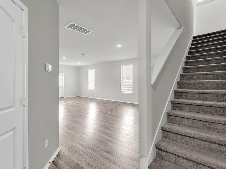 156 Janice Road Taylor, TX 76574 - Photo 15 of 29 Staircase with recessed lighting, visible vents, baseboards, and wood finished floors