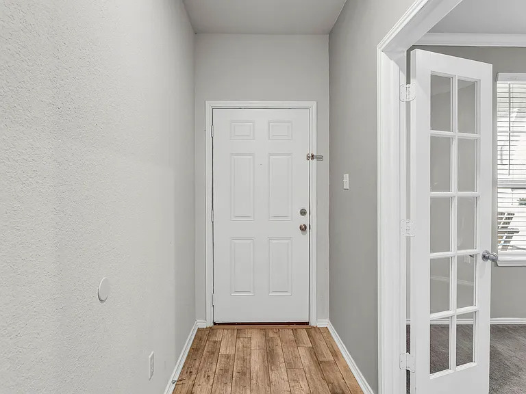 156 Janice Road Taylor, TX 76574 - Photo 2 of 29 Doorway to outside featuring baseboards and wood finished floors