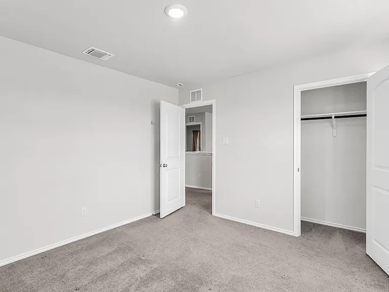 156 Janice Road Taylor, TX 76574 - Photo 26 of 29 Unfurnished bedroom featuring carpet, visible vents, and baseboards