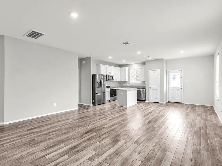 156 Janice Road Taylor, TX 76574 - Photo 5 of 29 Unfurnished living room featuring recessed lighting, visible vents, light wood-type flooring, and baseboards