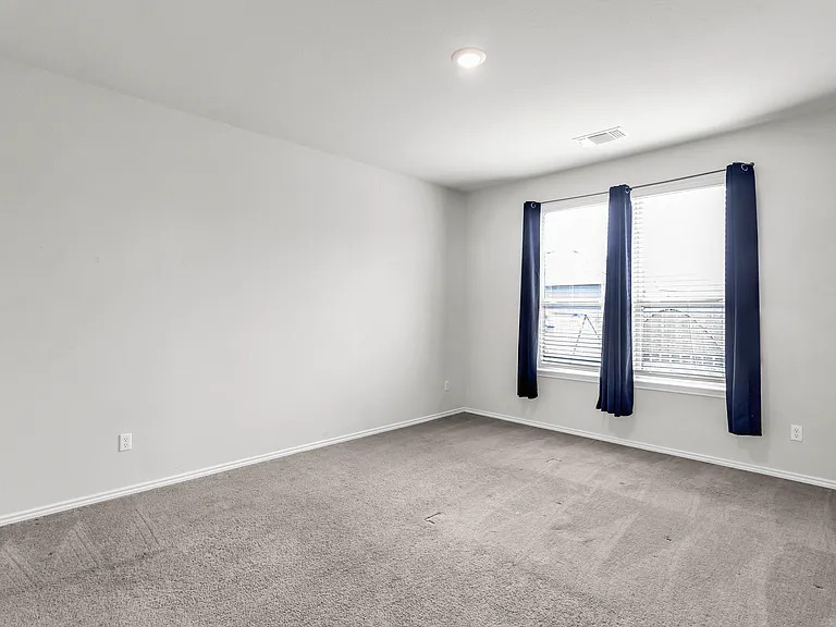 156 Janice Road Taylor, TX 76574 - Photo 10 of 29 Carpeted spare room with visible vents and baseboards