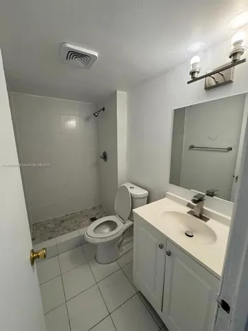 a bathroom with a sink toilet and vanity