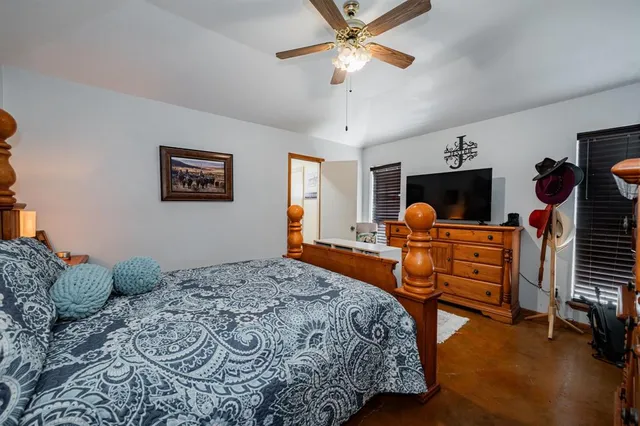 a bedroom with furniture and a chandelier