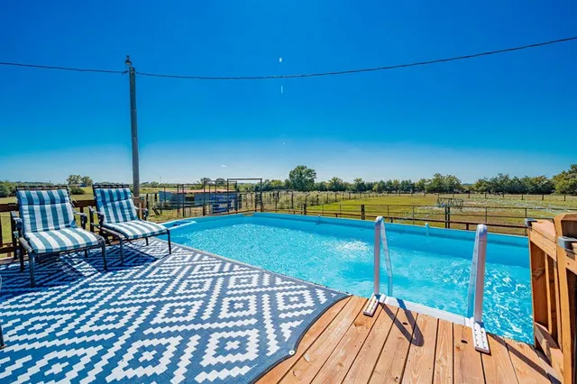a view of a swimming pool with lounge chairs