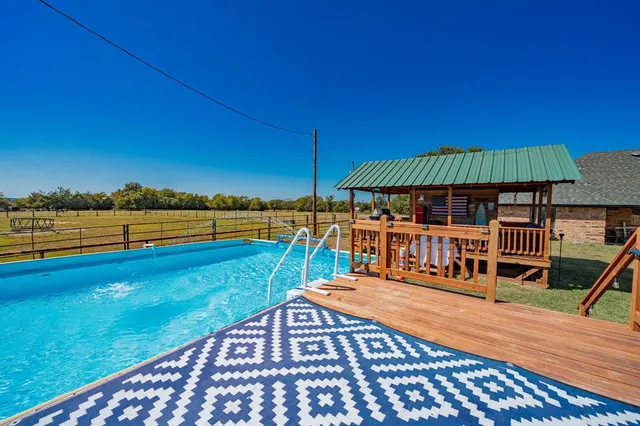 a view of outdoor space with deck and trees
