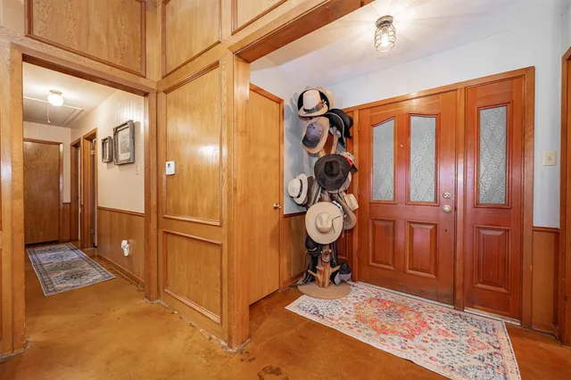 a view of a hallway with wooden floor and cabinets