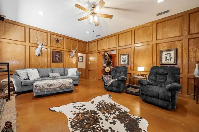 a living room with furniture ceiling fan and a rug